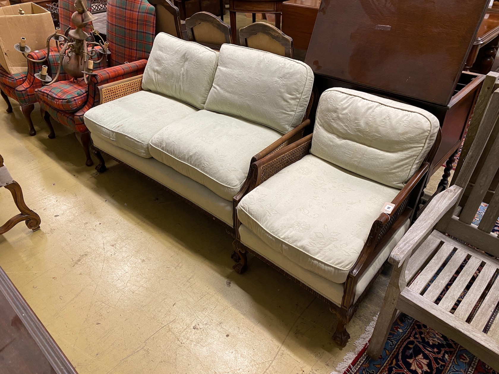 An early 20th century mahogany two piece bergere suite, settee length 130cm, depth 70cm, height 80cm